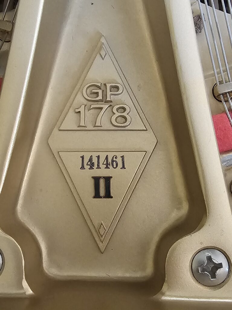 Close-up of the serial number on a Boston GP-178 grand piano.