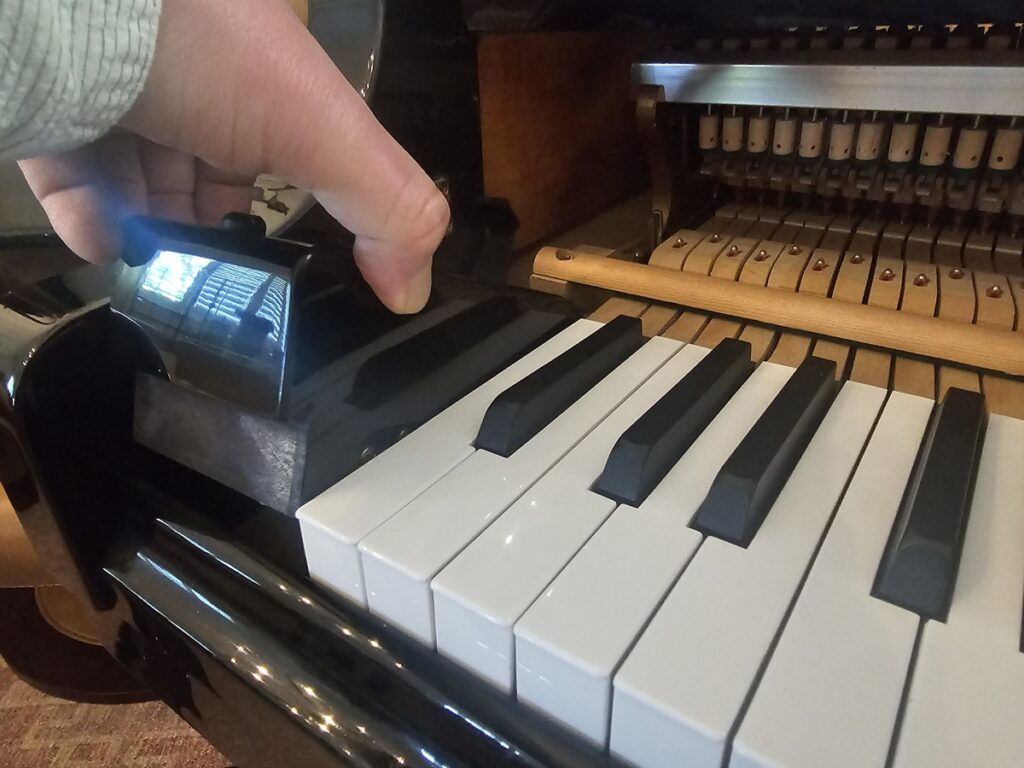 Removing the cheek blocks from a grand piano.
