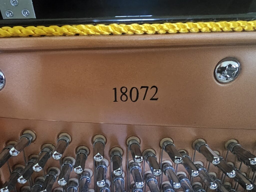 Close up of the serial number on a Hailun upright piano.