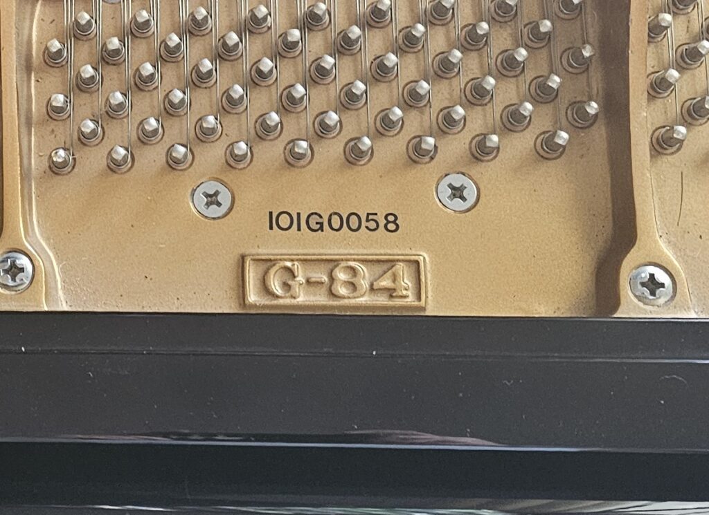 The model number on the cast iron plate of a Hyundai grand piano.
