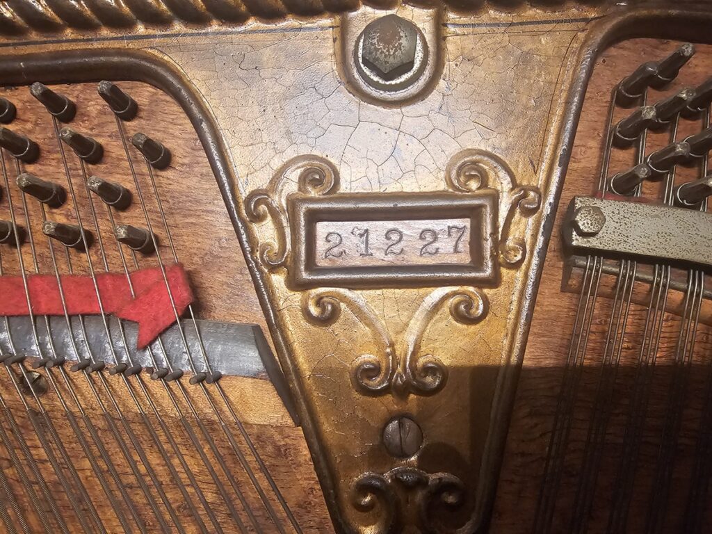 Close up of the serial number on a Schiller upright piano.