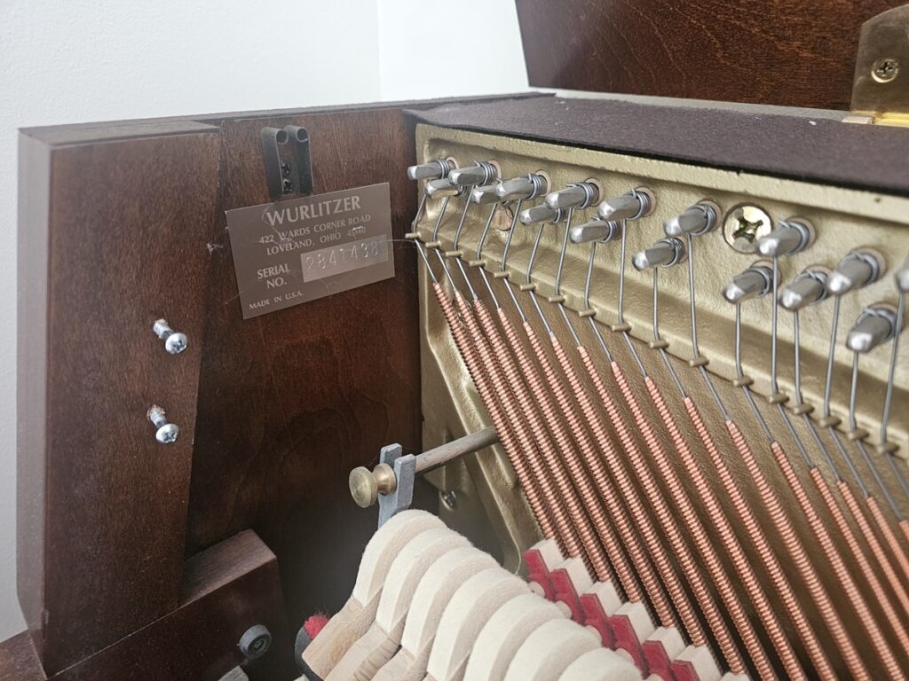 Close up of the serial number on a Wurlitzer studio piano.