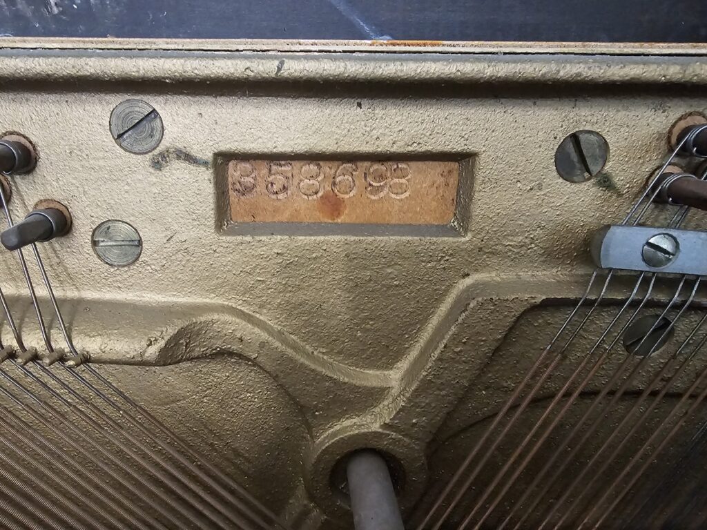 Close up of the serial number on a Wurlitzer spinet piano.