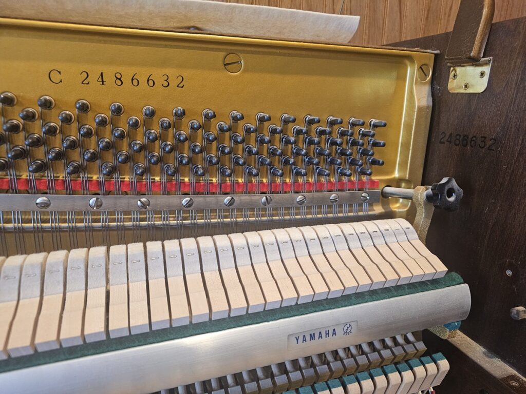 Yamaha upright piano showing it's serial number.