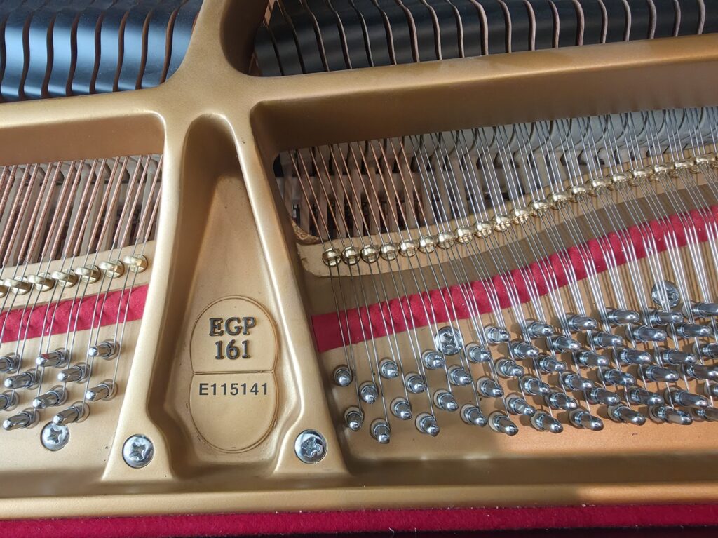 Close-up of the serial number on an Essex grand piano.