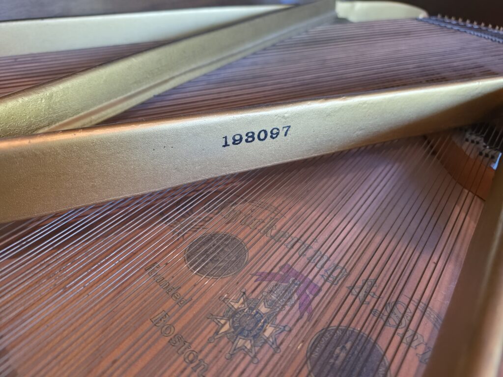 Close-up of the serial number on a Chickering Grand piano.