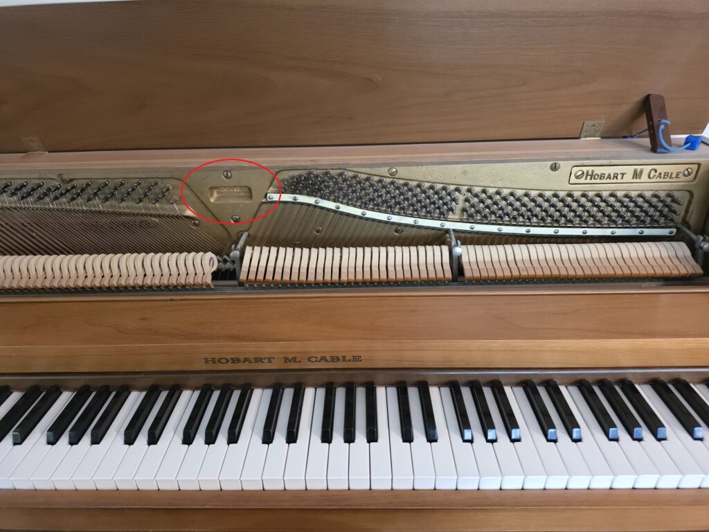 Hobart M. Cable spinet with lid open, which reveals the serial number.