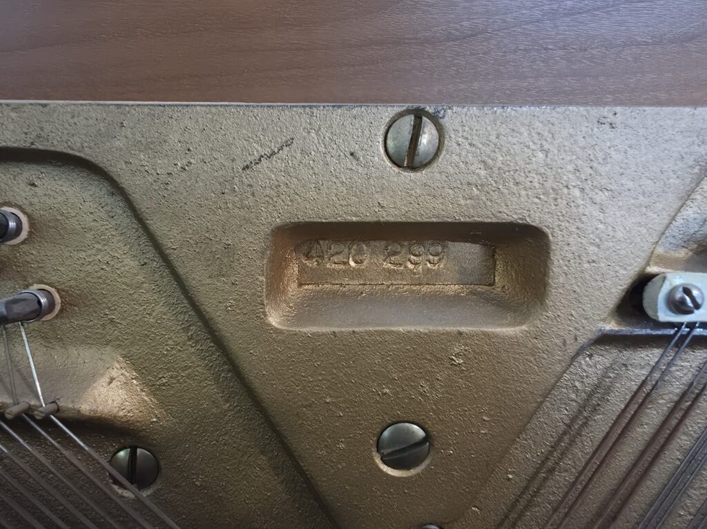 Close-up of the serial number on a Hobart M. Cable spinet piano.