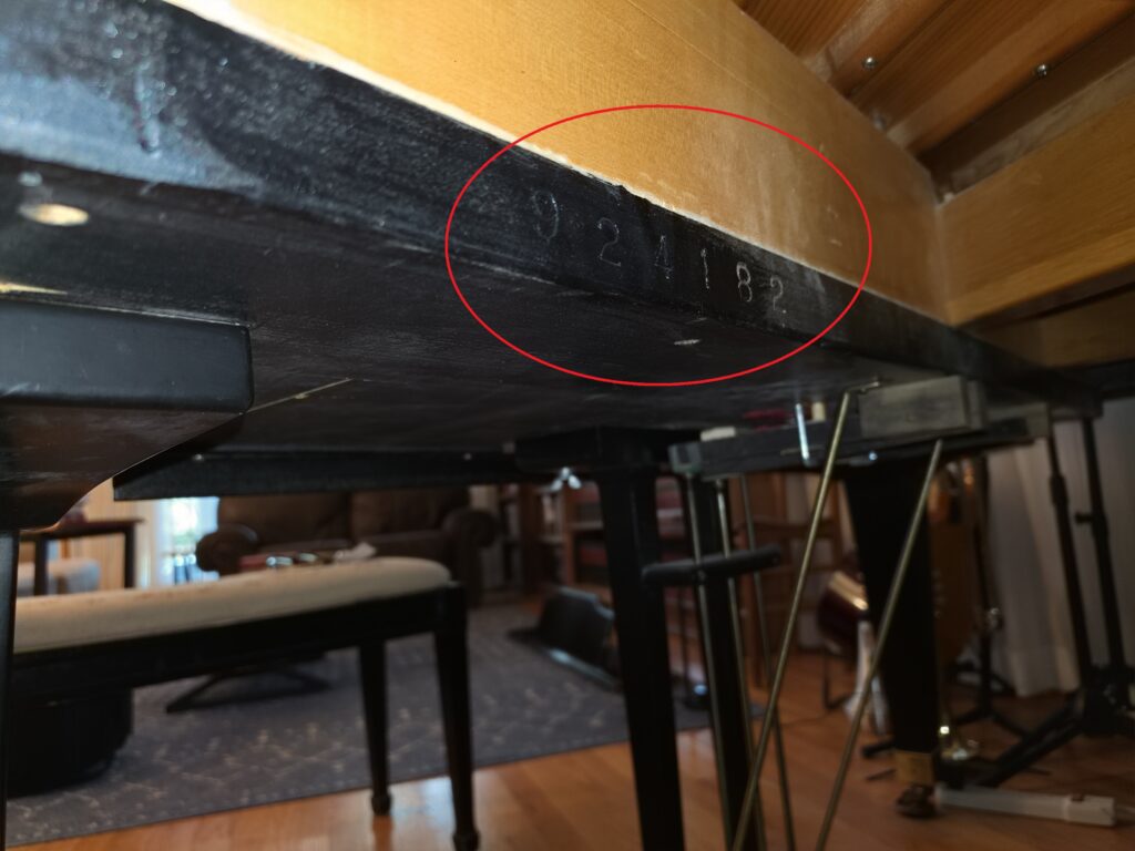 Close-up of the serial number on a modern Kimball grand piano.
