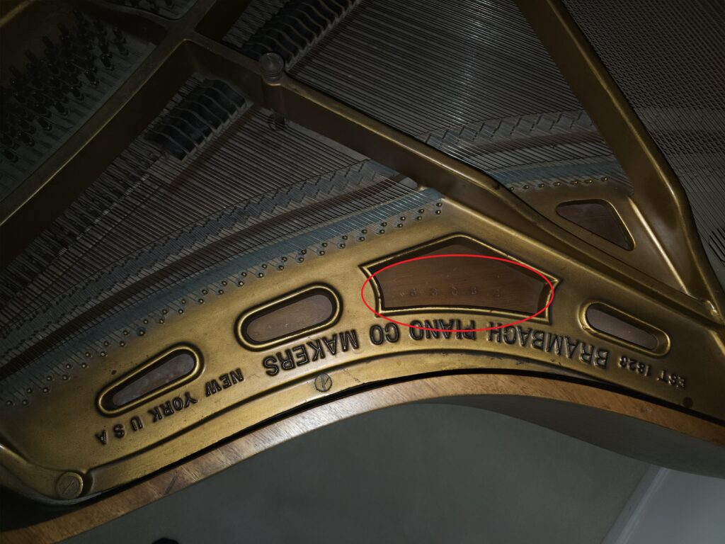 View from the side of a Brambach grand, showing the unusual location of the serial number.
