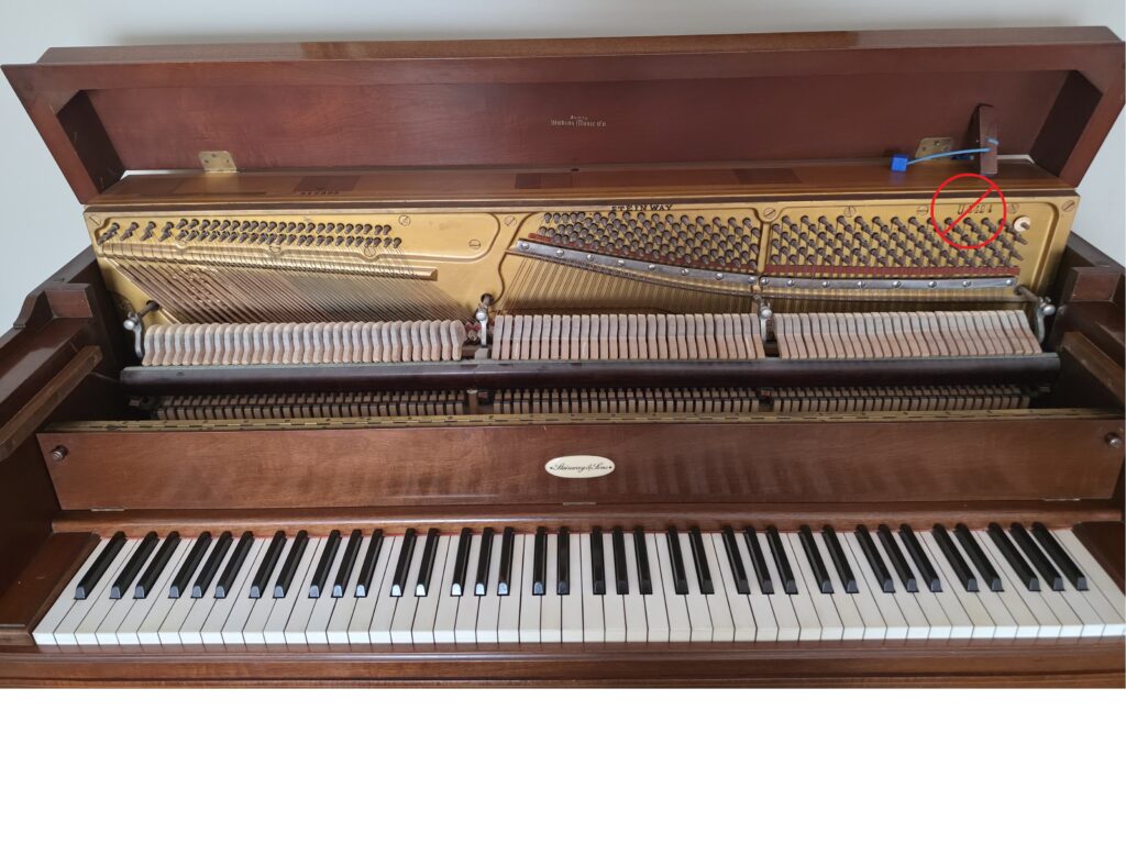A Steinway console with its lid open.